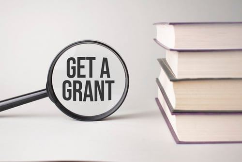 The,Inscription,Get,A,Grant,Is,Written,And,The,Books. - fundsforNGOs