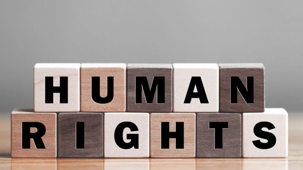 education and sports for children 1 - fundsforNGOs Wooden letter blocks spell 'HUMAN RIGHTS' on a wooden table, arranged in two rows.