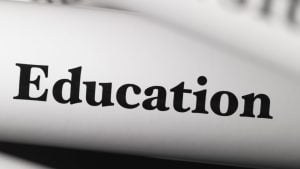 Close-up of the word 'Education' printed in bold on a curved white surface.