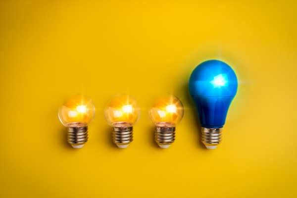 Technologies and Innovation - fundsforNGOs Four light bulbs in a row on a yellow background; three small incandescent bulbs lit and one larger blue bulb lit on the right.