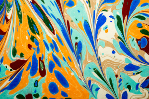 Abstract marbled pattern with orange, blue, teal, and beige swirls.