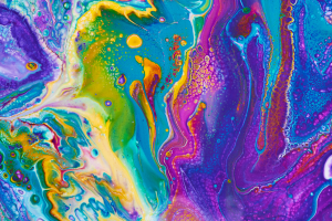 Vibrant abstract acrylic pour with swirling blues, purples, yellows, and greens forming organic marbled patterns.