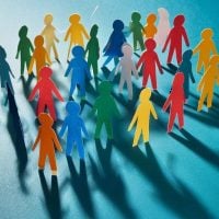 community 2 - fundsforNGOs Diverse group of colorful paper people standing together, symbolizing inclusion and community.