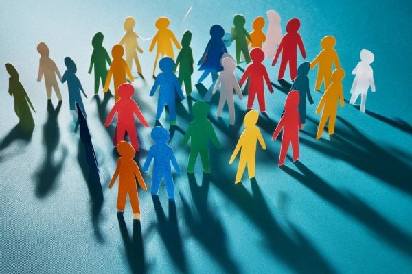 community 2 - fundsforNGOs Diverse group of colorful paper people standing together, symbolizing inclusion and community.