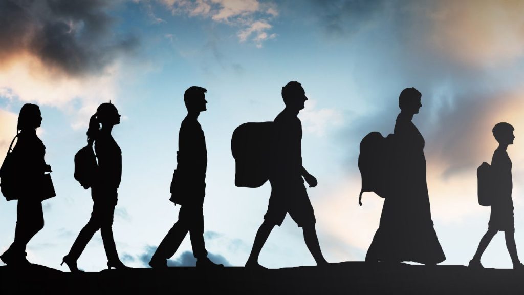 education and sports for children - fundsforNGOs Silhouettes of five students walking in a line with backpacks against a cloudy sky at sunset/date line horizon.