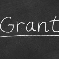 fundsforNGOs - 2026-06-02T123524079 - fundsforNGOs The word 'Grant' written in chalk on a blackboard with an underline underneath it.