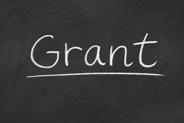 The word 'Grant' written in chalk on a blackboard with an underline underneath it.