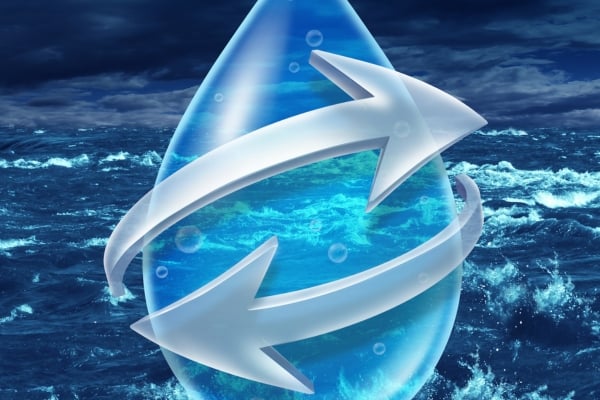 Blue water drop with white circular arrows around it, symbolizing refresh or reload against a sea background.