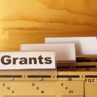 grant 1 - fundsforNGOs Label reading 'Grants' on a filing cabinet drawer with blank index tabs nearby.
