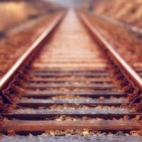 rail - fundsforNGOs Railroad tracks stretch into the distance through an autumn landscape with fallen leaves on and between the rails.