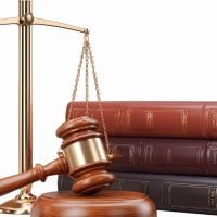 education and sports for children - fundsforNGOs Gold scales of justice beside a wooden gavel and a stack of legal books, symbolizing law and justice.